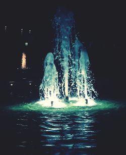 View of illuminated swimming in sea at night