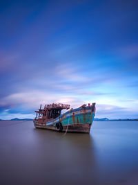 Wrecked fishing boats washed ashore by the sea