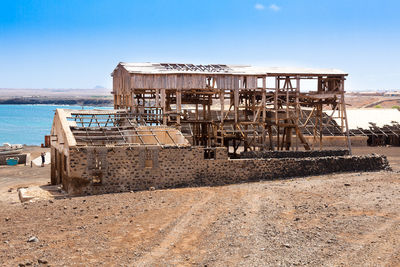 Abandoned built structure on beach against clear sky