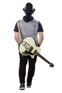 Rear view of man holding guitar against white background