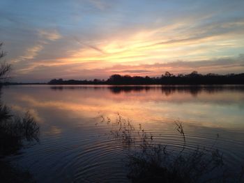 Scenic view of lake at sunset