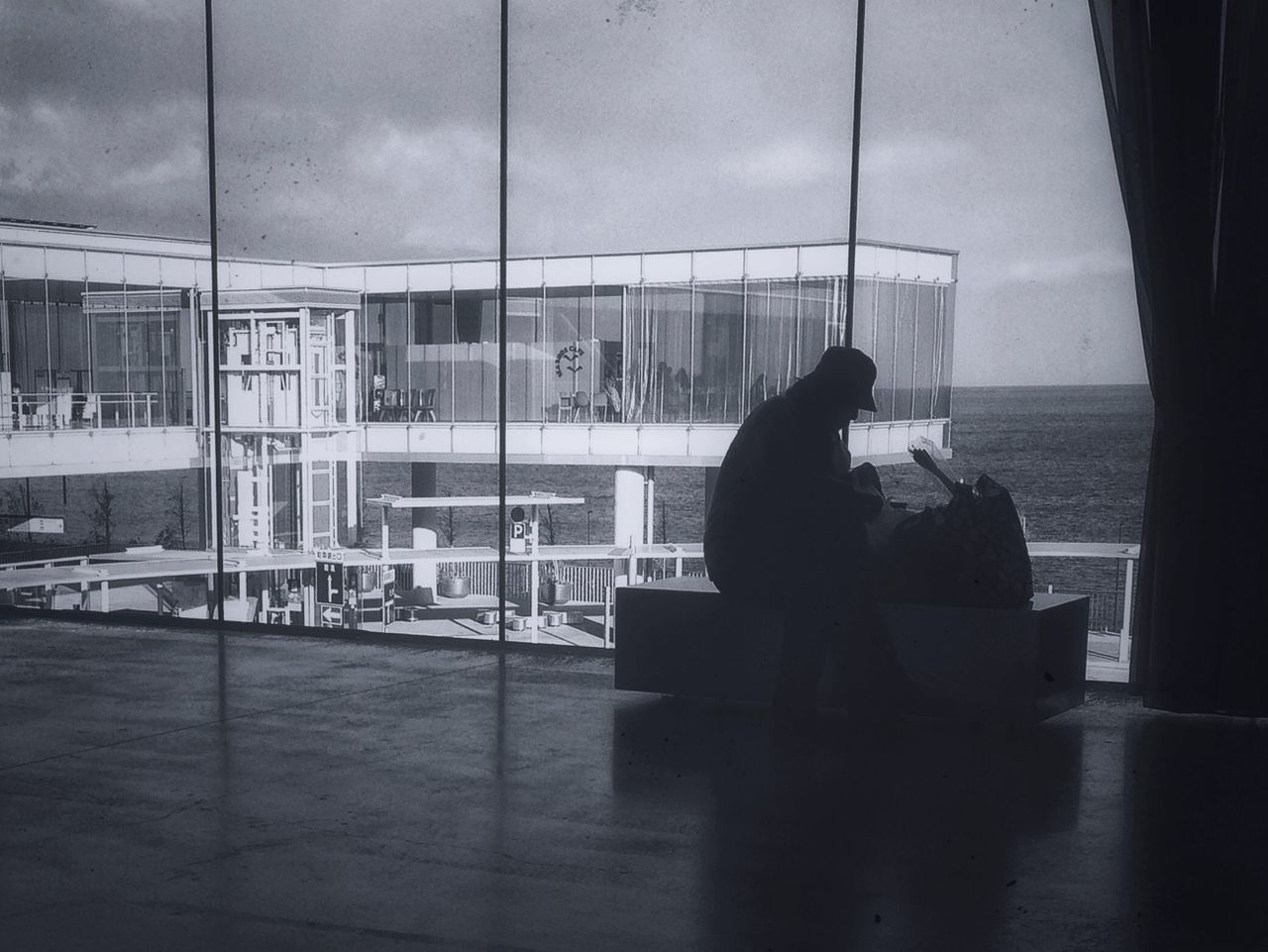 sky, sea, window, indoors, water, built structure, architecture, glass - material, cloud - sky, horizon over water, sitting, transparent, building exterior, silhouette, reflection, day, cloud, men, rear view, sunlight