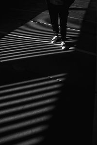 Low section of woman walking on tiled floor