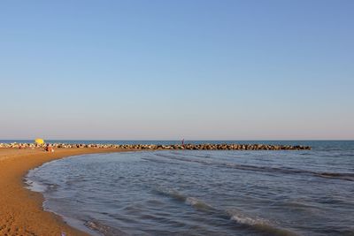 Scenic view of beach against clear sky