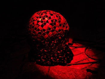 Close-up of illuminated lighting equipment against black background