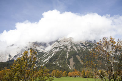 Scenic view of mountains against cloudy sky