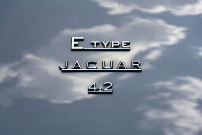 Low angle view of information sign against sky