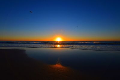 Scenic view of sea against clear sky during sunset