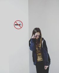 Woman leaning against wall