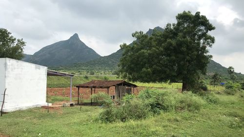 Built structure on field against sky