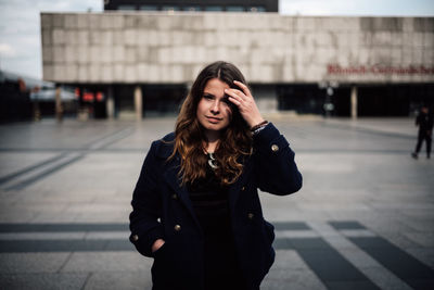 Portrait of a beautiful young woman standing outdoors