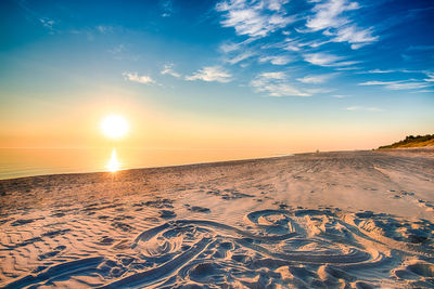 Scenic view of beach against sky during sunset