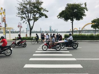 People riding motorcycle on city street