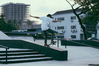 Man skateboarding at park in city