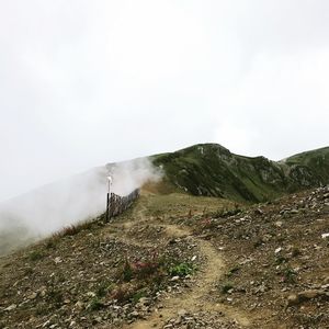 Scenic view of geysers on mountain against sky