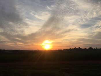 Scenic view of field against sky during sunset