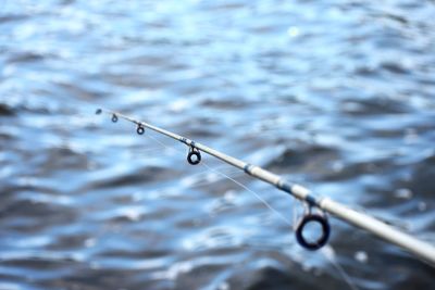 Close-up of fishing rod on lake