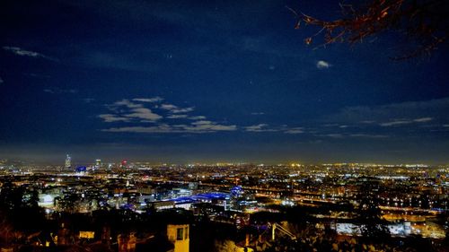 High angle view of illuminated city buildings against sky