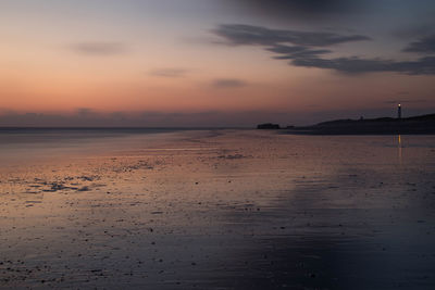 Scenic view of sea against sky at sunset