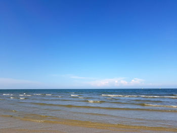 Scenic view of sea against blue sky