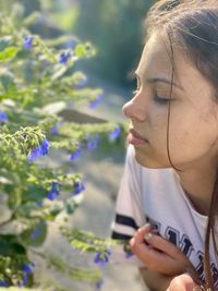 Side view of young woman using mobile phone