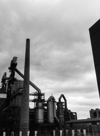 Low angle view of factory against sky