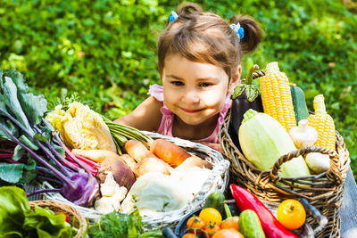 Portrait of smiling girl with vegetables in basket