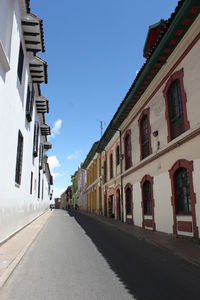 Empty road with buildings in background