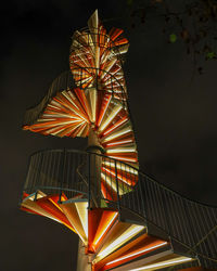 Low angle view of illuminated ferris wheel against sky at night