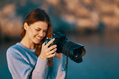 Young woman using mobile phone outdoors