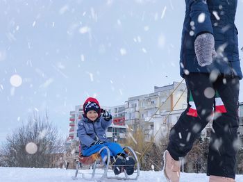 Full length portrait of people in snow during winter