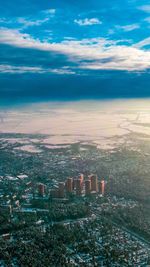 High angle view of city against cloudy sky