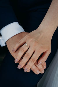 Midsection of couple holding hands