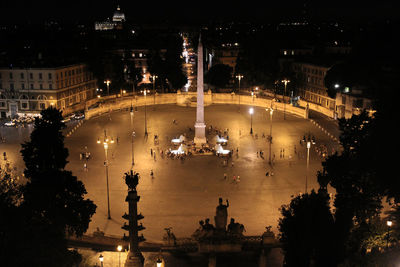 Statue of illuminated city against sky at night