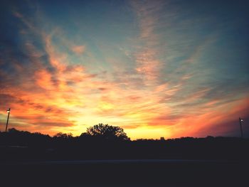 Scenic view of silhouette landscape against orange sky