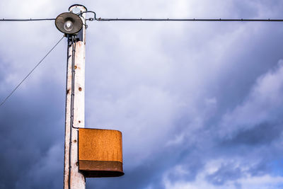 Low angle view of street light against sky