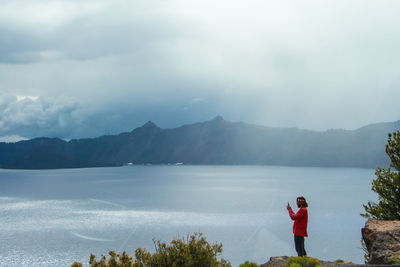 Man standing on mountain against sky