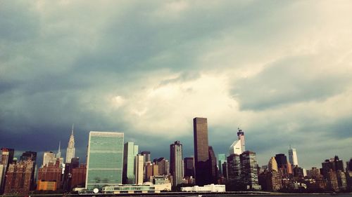 Cityscape against cloudy sky