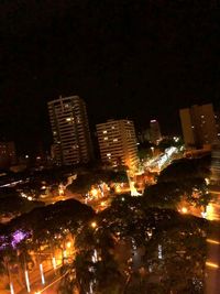 High angle view of illuminated buildings against sky at night