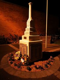 Illuminated lamp by building at night