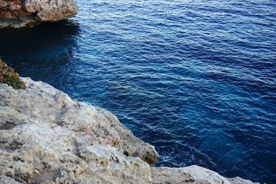 High angle view of rock formation in sea