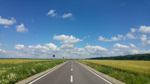 Empty road along countryside landscape