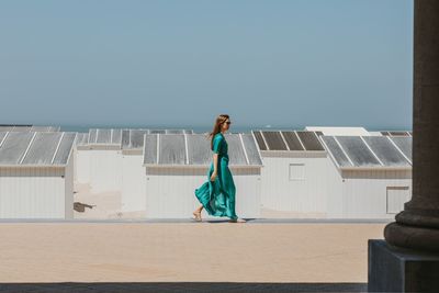 Full length of woman standing against sky