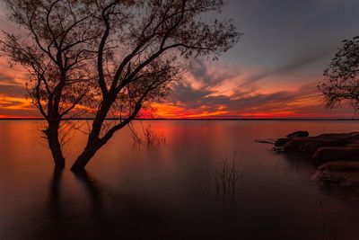Scenic view of lake against romantic sky at sunset