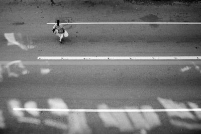 High angle view of man walking on road