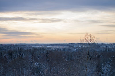 Scenic view of snow covered landscape against sky during sunset