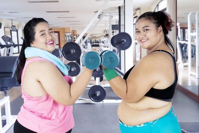 Female friends exercising in gym