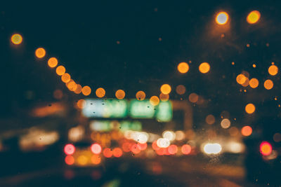 Defocused image of illuminated city street at night