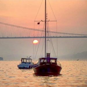 Sailboat in sea at sunset