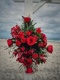 Close-up of red rose bouquet against sky